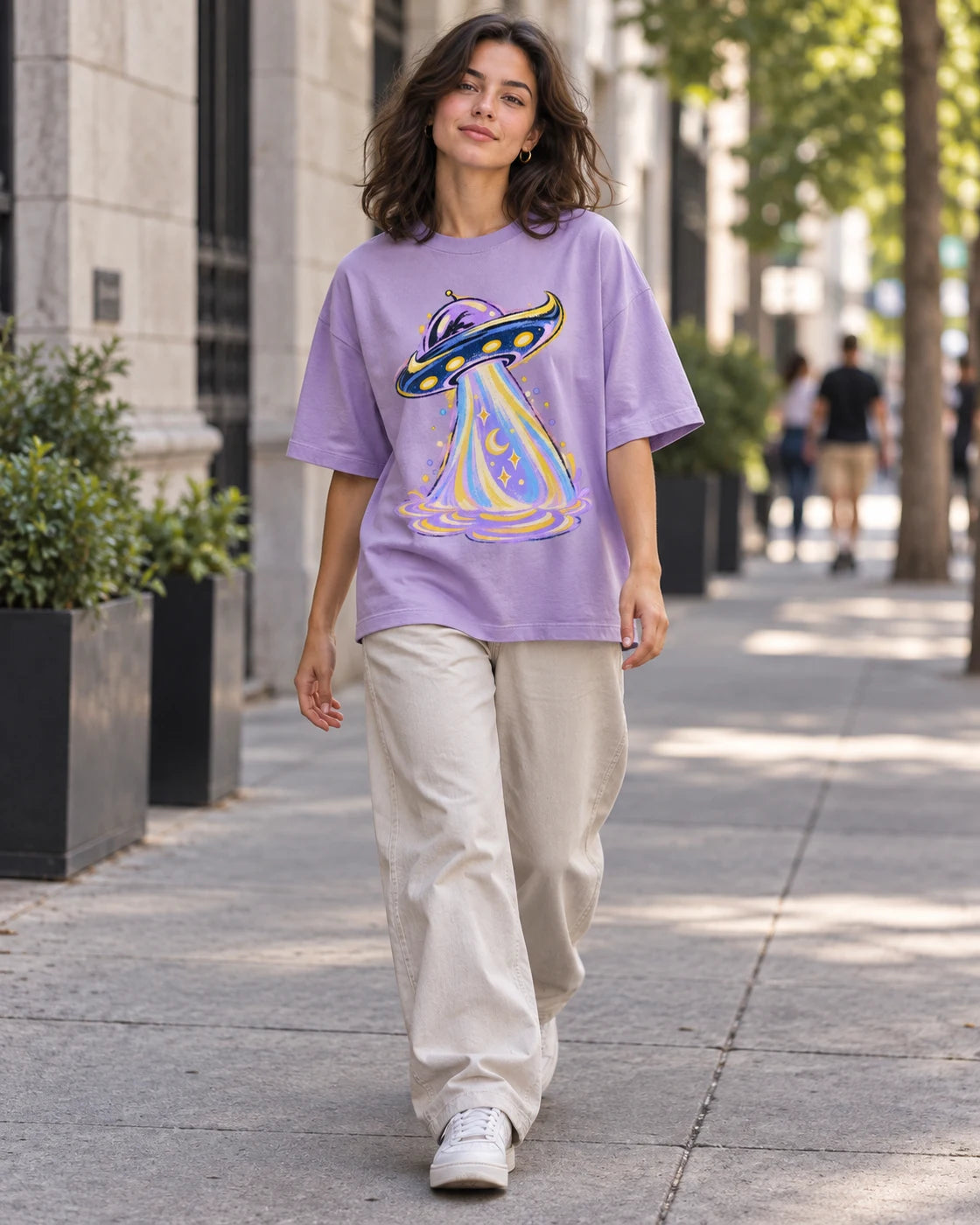 Woman walking down a city street in the Moonbeam Club lavender French terry oversized tee
