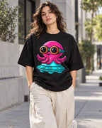 Woman on a street in a black oversized French terry t-shirt with a pink octopus in goggles flying a teal UFO