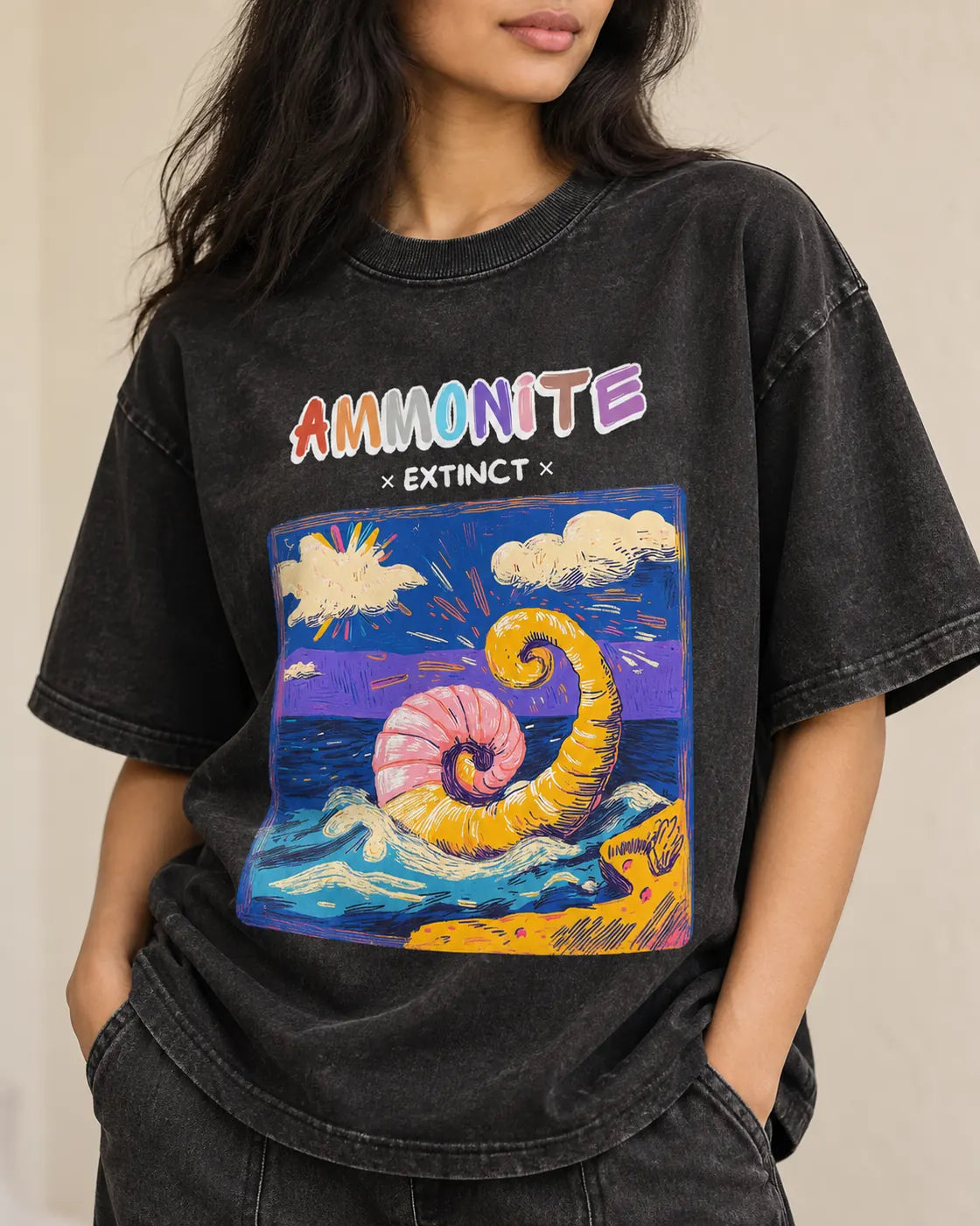 Close-up of the Ammonite Ancient Archives print on a black acid wash oversized T-shirt