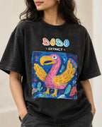 Close-up of the Dodo Ancient Archives print on a black acid wash oversized T-shirt