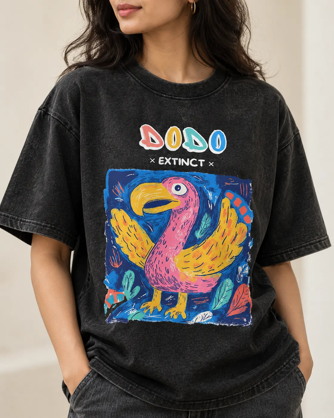 Close-up of the Dodo Ancient Archives print on a black acid wash oversized T-shirt