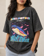 Close-up of the Dunkleosteus Ancient Archives print on a black acid wash oversized T-shirt