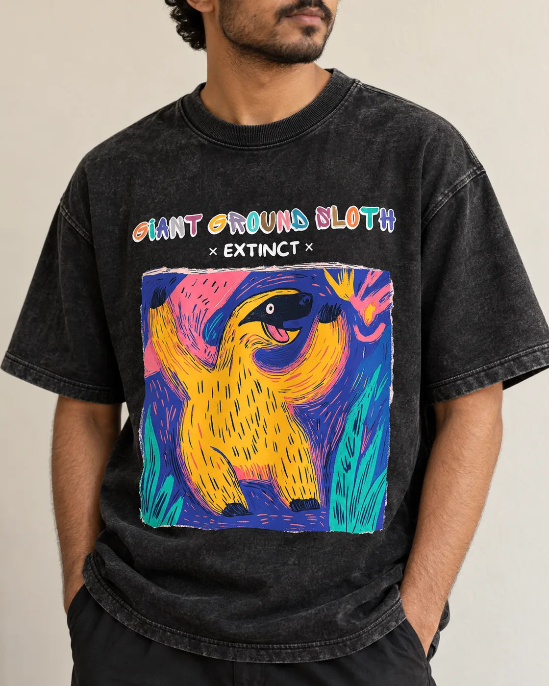 Close-up of the Giant Ground Sloth Ancient Archives print on a black acid wash oversized T-shirt
