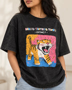 Close-up of the Saber-toothed Tiger Ancient Archives print on a black acid wash oversized T-shirt