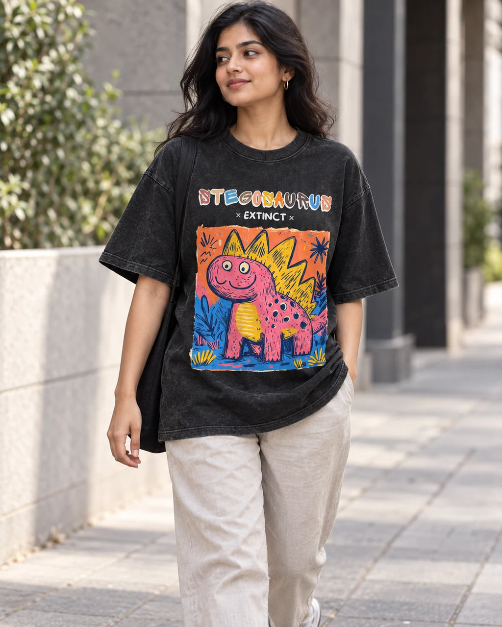 Model wearing the Stegosaurus black acid wash oversized T-shirt on a city street, Fourth Dimension Club