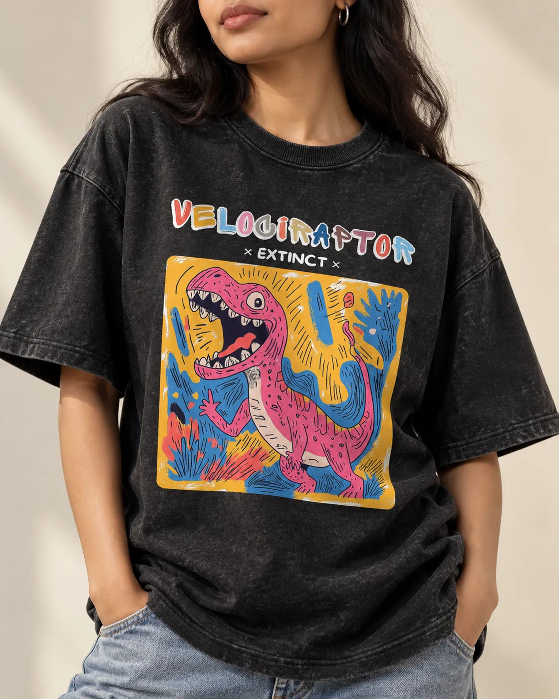 Close-up of the Velociraptor Ancient Archives print on a black acid wash oversized T-shirt