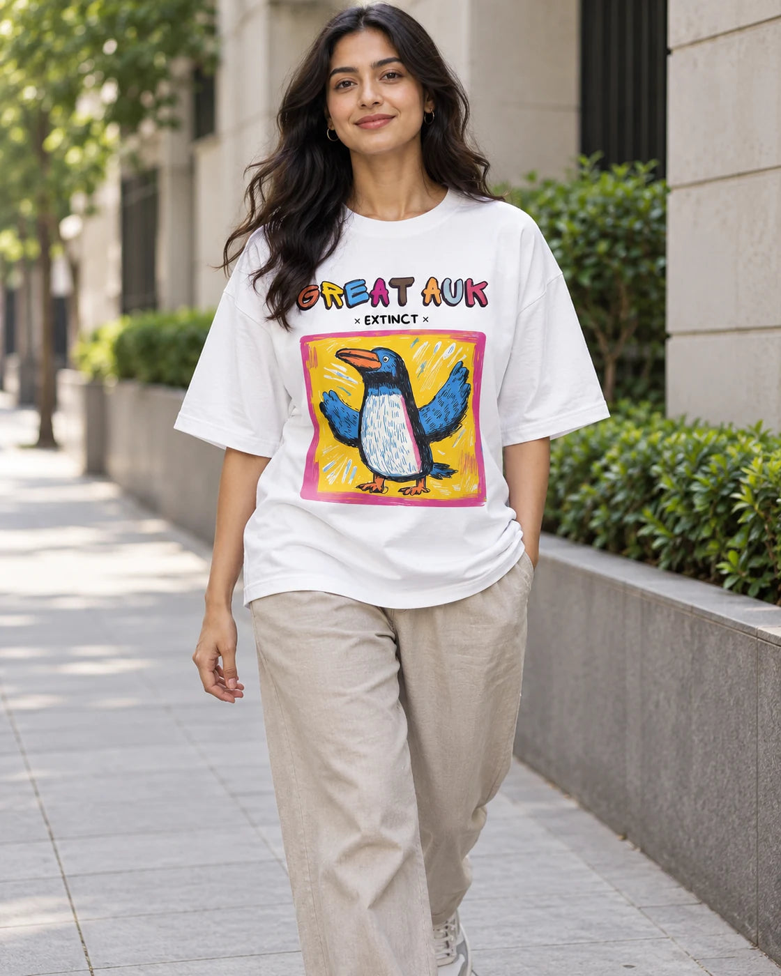 Model wearing the Great Auk white oversized French terry T-shirt on a city street, Fourth Dimension Club