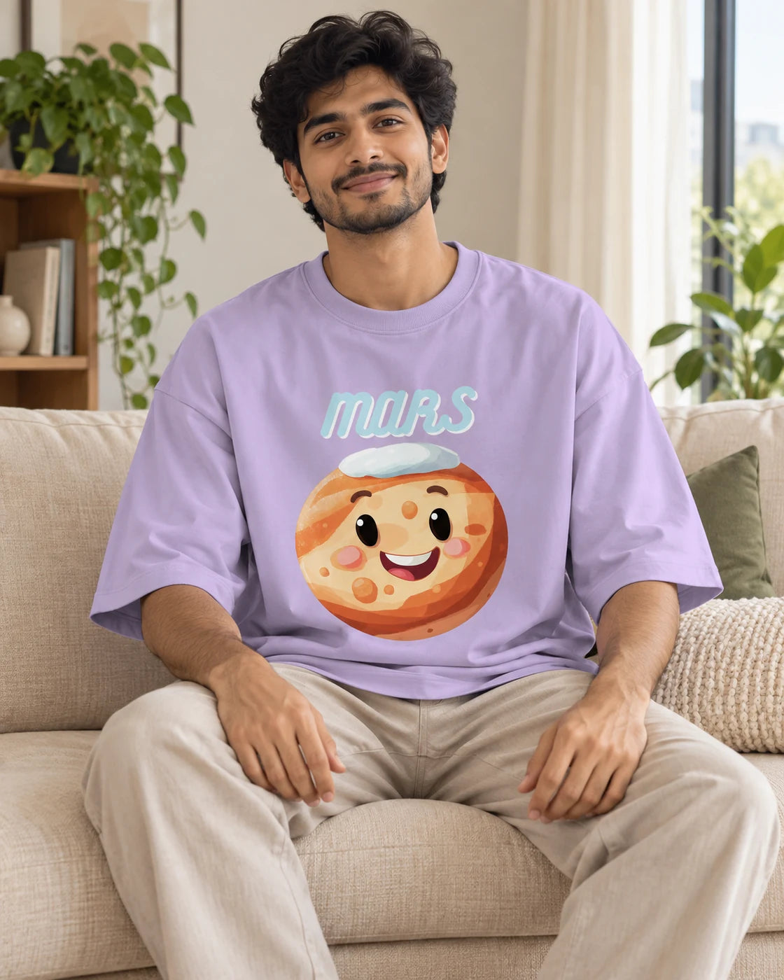 Model wearing the Mars Stellar Squad oversized French terry T-shirt in lavender by Fourth Dimension Club, seated on a sofa